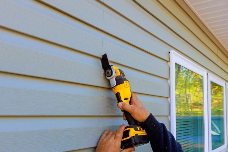Professional Siding Installer Using Power Tools